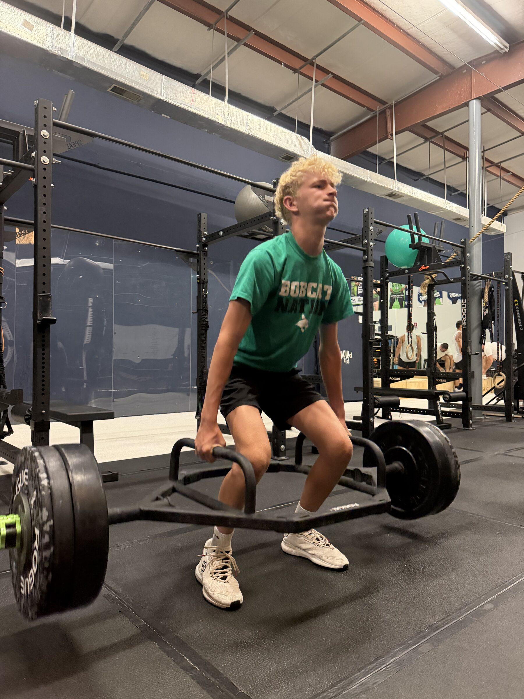 High school athlete deadlifting with a trap bar at TideHaus Fitness