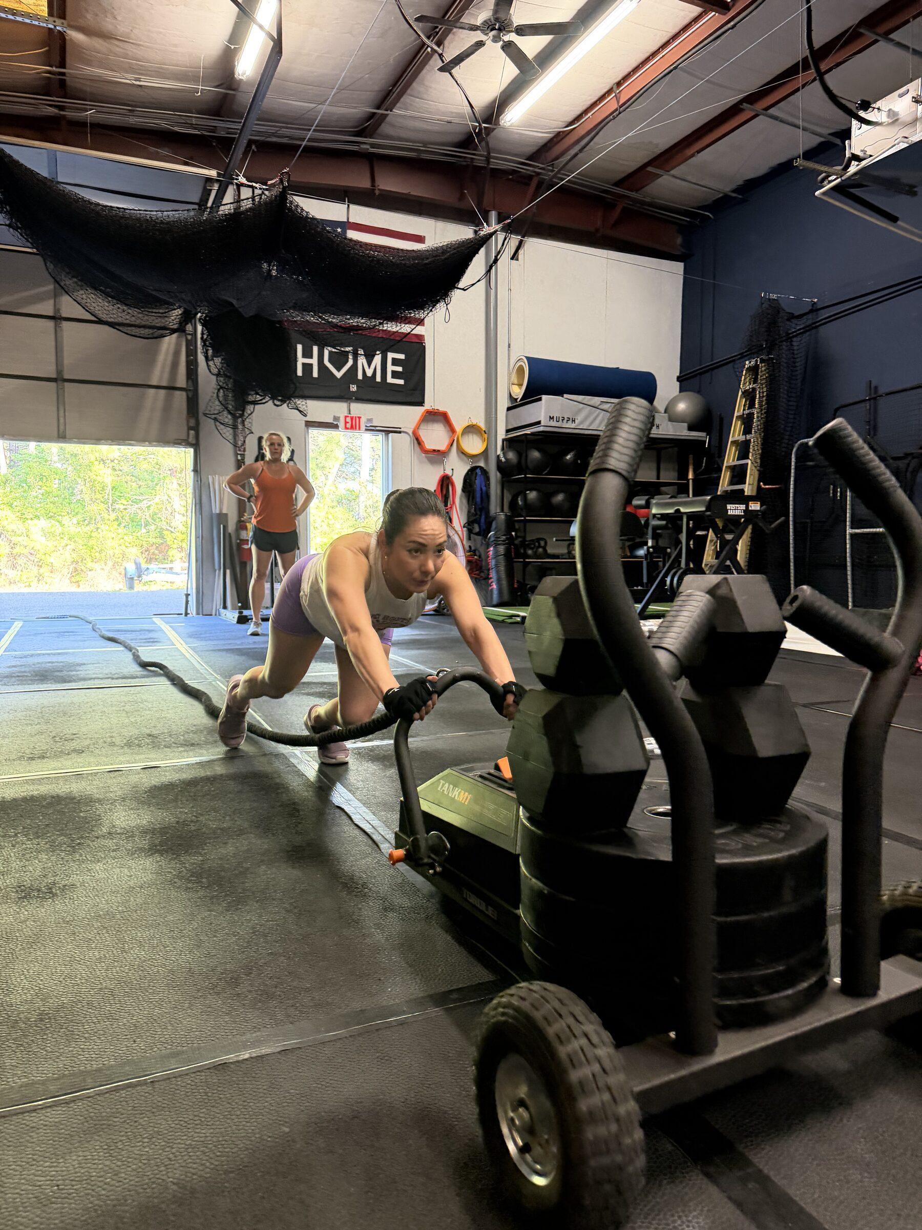 Athlete performing a sled push at TideHaus Fitness